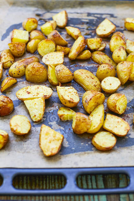 Roasted halved Potatoes on baking tray — Stock Photo