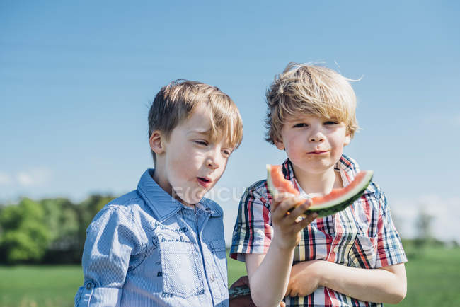 Boys eating watermelon — Stock Photo