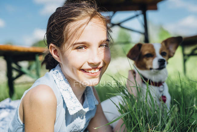 Girl with dog in meadow — Stock Photo