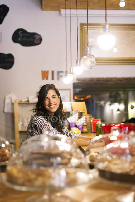 Young woman working in her own little cafe — Stock Photo