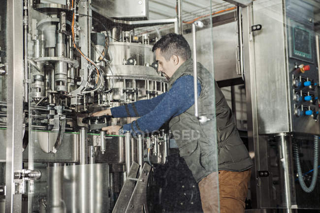 Giovane che lavora nel birrificio artigianale — Foto stock