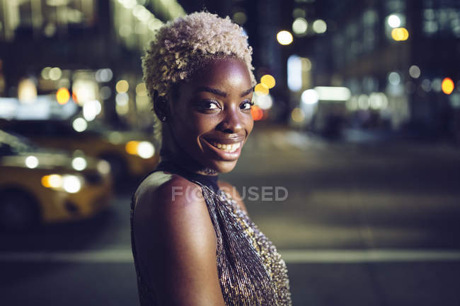 Portrait of cool african american woman on Times Square at nighttime, USA, New York City — Stock Photo