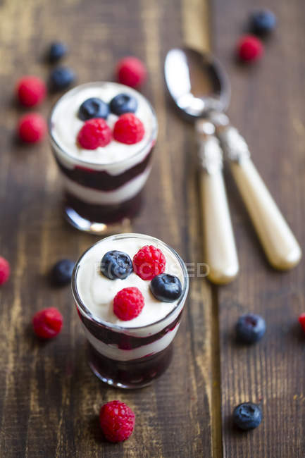 Yogurt Con Gelatina Di Frutta Rossa Mirtilli E Lamponi In Bicchieri Su Legno Cucchiai Iogurt Stock Photo 177226814