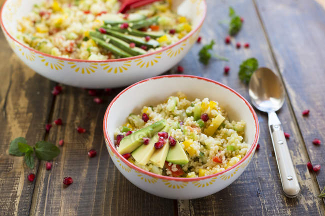 Closeup view of bulgur salads with avocado in bowls — Stock Photo