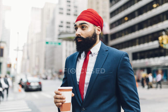 Indian businessman with coffee cup at city, Manhattan, NY, USA — Stock Photo