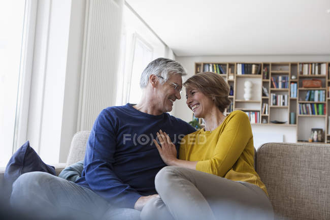 Happy mature adult couple in the living room — Stock Photo