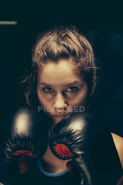 Portrait of female boxer with boing gloves — Stock Photo
