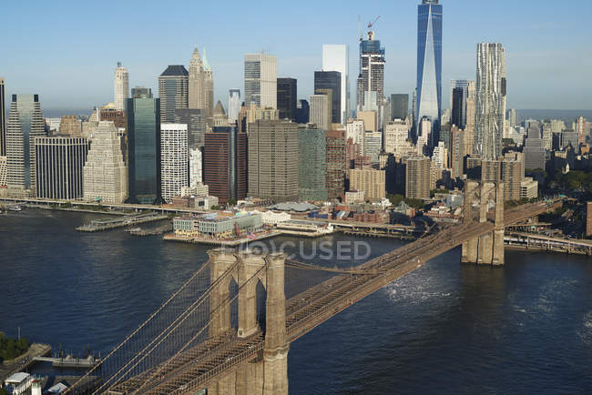 USA, New York, Aerial view of the Brooklyn Bridge and cityscape in sunlight — Stock Photo