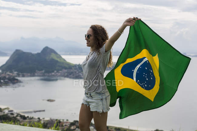 Brazil, woman with Brazilian flag on a viewpoint in Rio de Janeiro — Stock Photo