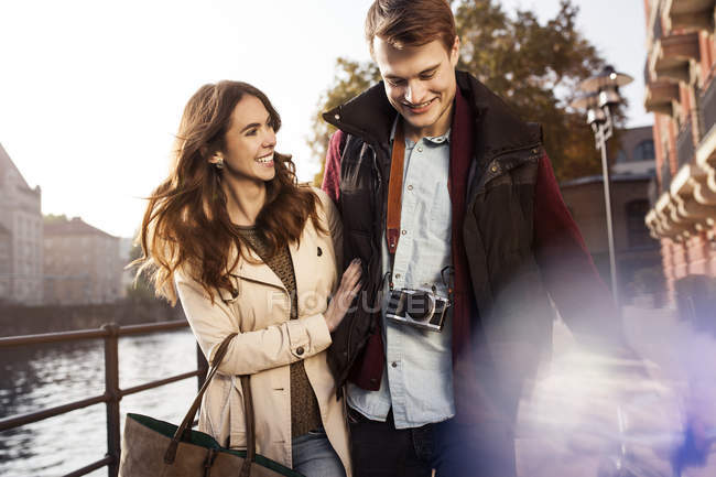 Germany, Berlin, happy young couple walking along River Spree — Stock Photo