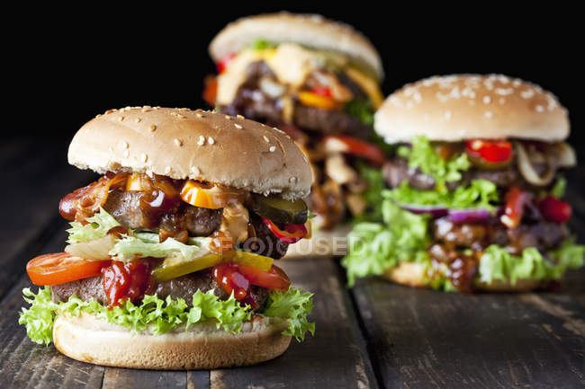 Double burgers with vegetables — Stock Photo