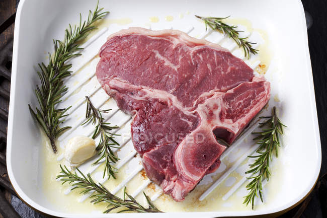 Raw porterhouse steak with rosemary — Stock Photo