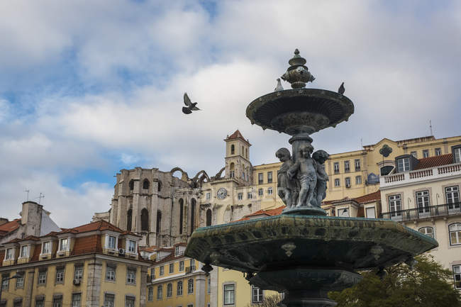 Portugal, Lisbon, fountain and Igreja do Carmo monastery in the background — Stock Photo