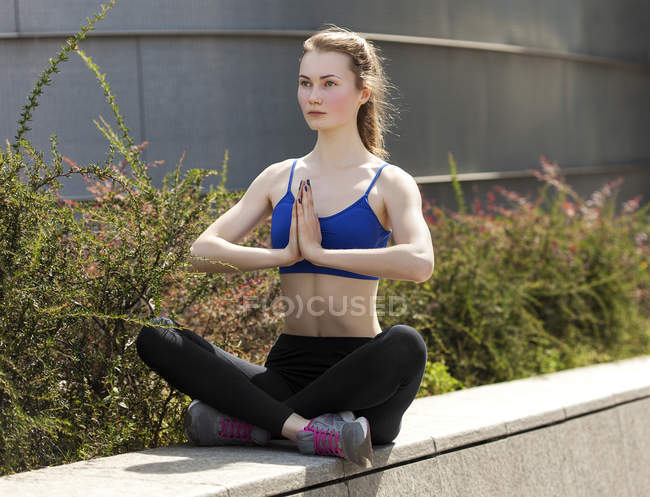 Jovem praticando ioga na cidade — Fotografia de Stock