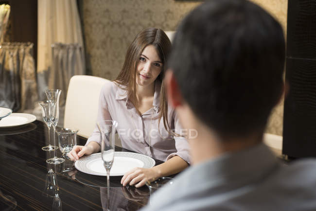 Young woman in love looking at man at dining table — Stock Photo