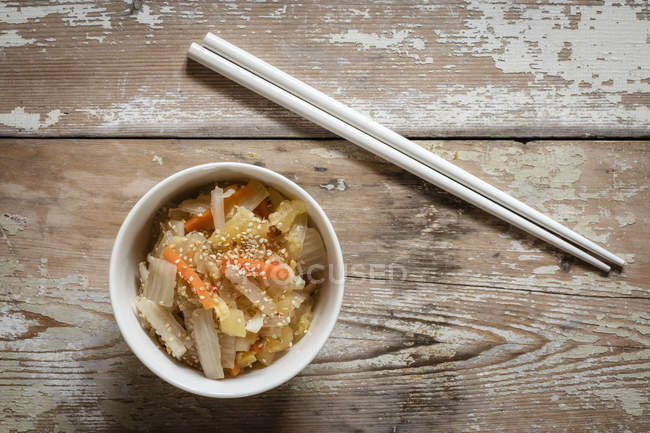 Kimchi fermented Korean dish with chopsticks on wood — Stock Photo