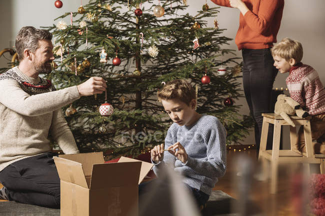 Family Decorating Christmas Tree At Home Care Male Stock Photo 177566616 - A Family By Decorating Christmas Tree At Home