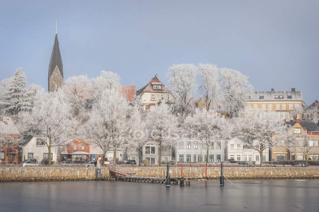 Germany, Eckernfoerde, Harbour in winter with Borby Church in background — Stock Photo