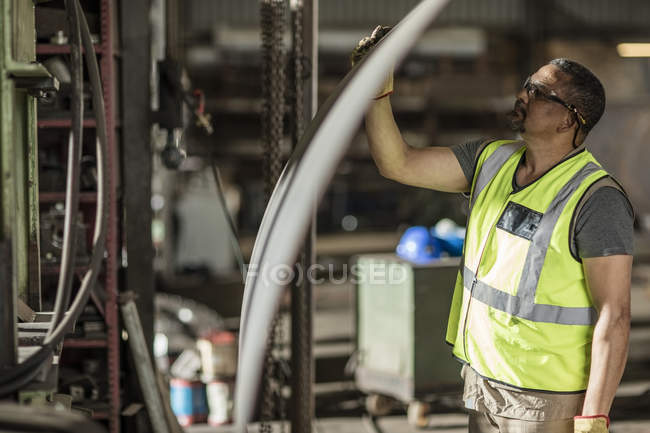 Engineer examining construction parts at workshop — Stock Photo