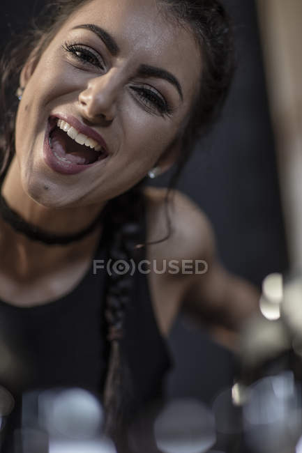 Portrait of female rock singer against blurred background — Stock Photo