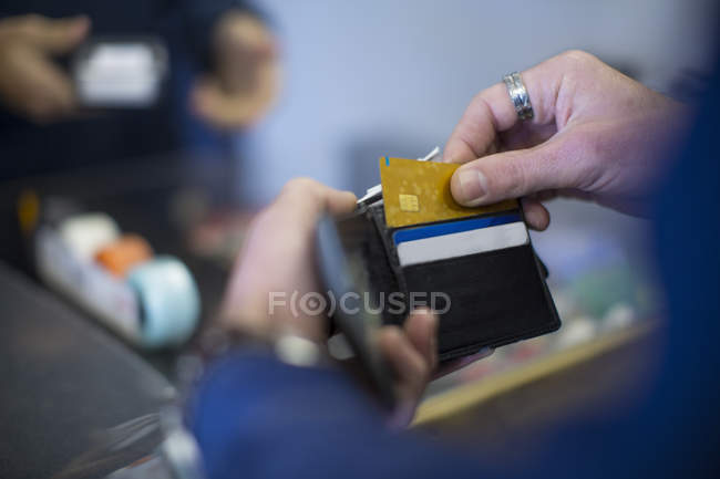 Cropped image of man holding wallet with cards — buying, payment ...