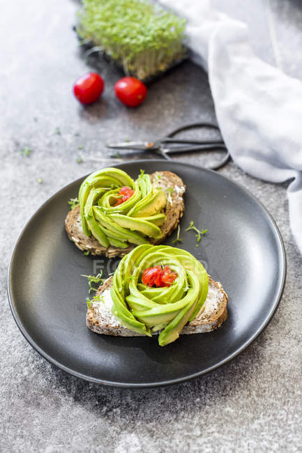 Avocado rose, bread, cress and tomatoes — Stock Photo