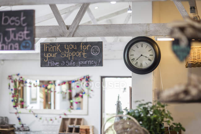 Interior view with chalkboards and clock in a farm shop — Stock Photo