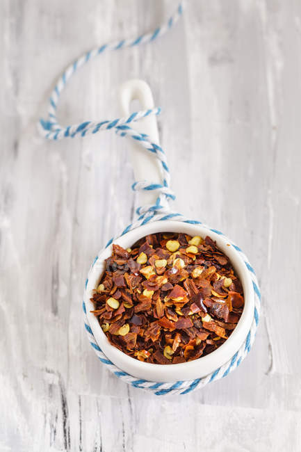 Closeup view of small bowl with chili flakes — Stock Photo