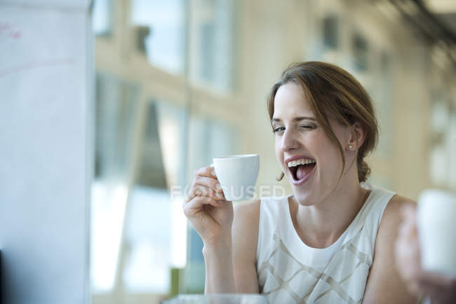 Portrait of playful businesswoman winking — Stock Photo