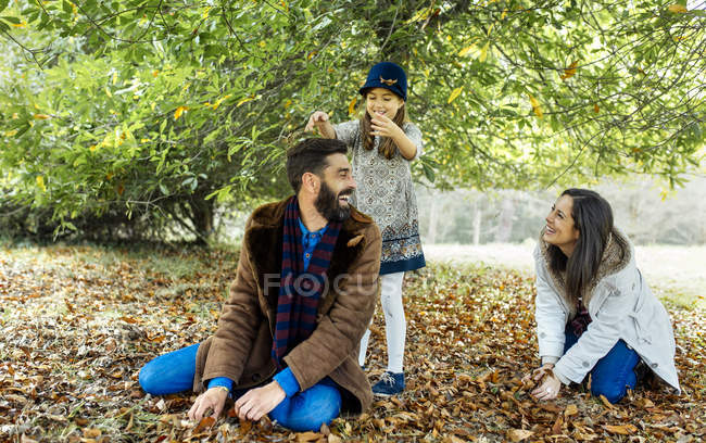 Parents and daughter having fun together in nature — Stock Photo