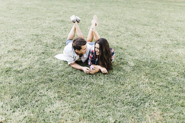 Couple in love lying on meadow — Stock Photo