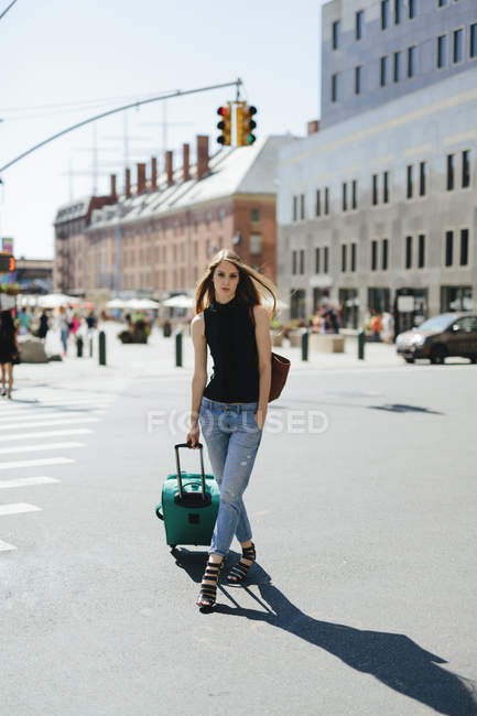 Young Woman With Rolling Suitcase Standing On A Street Urban Scene People Stock Photo 178191062