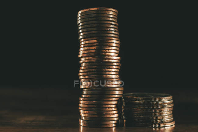 Stack of coins on black background — Stock Photo