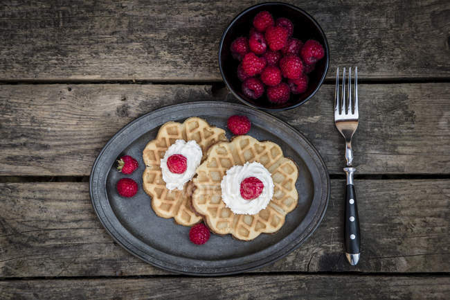 Waffles with raspberries and whiped cream — Stock Photo