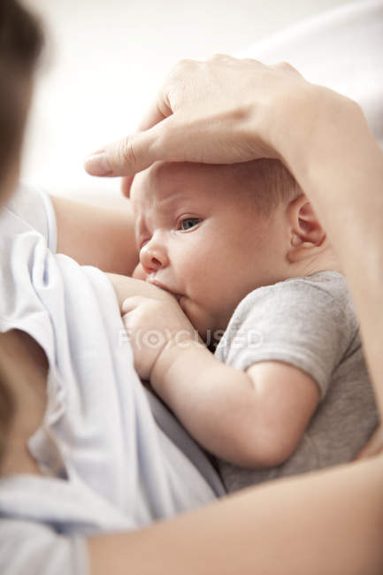 Young woman breast feeding her baby — Stock Photo