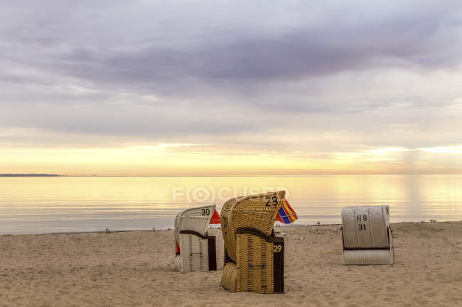 Germany, Niendorf, Three Hooded Beach Chairs On Timmendorfer Strand At 