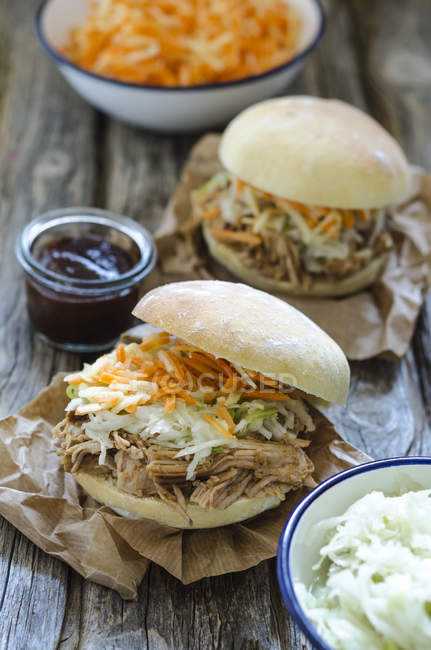 Homemade pulled pork with carrot and cabbage salad on hamburger bun — Stock Photo