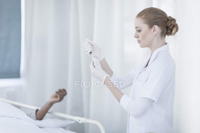 Focused Nurse holding injection in a hospital — Stock Photo