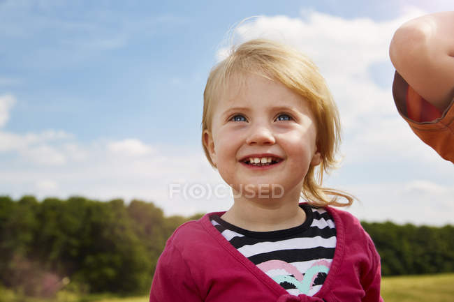 Портрет счастливая блондинка девочка смотрит вверх на луг — стоковое фото