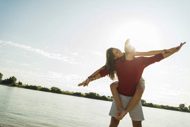 Carefree young couple by the river — Stock Photo