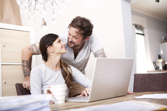 Pareja Feliz Juntos En Casa Usando El Ordenador Portatil Mujer Ropa Casual Stock Photo