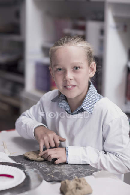 Portrait of smiling girl in art class at school — Stock Photo