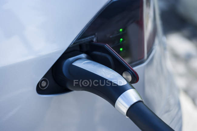 Closeup of charging process of electric car at daytime — Stock Photo