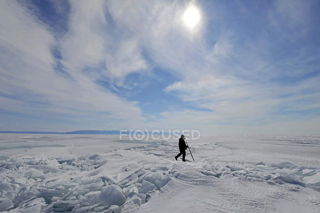 Russia, Lake Baikal, man walking on frozen lake — Stock Photo