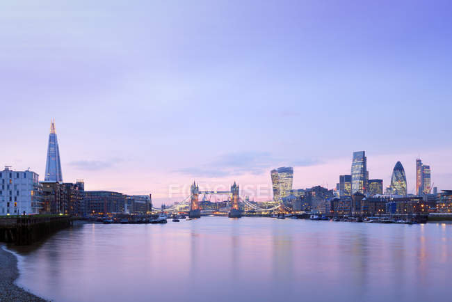 UK, London, skyline with River Thames and Tower Bridge at dawn ...