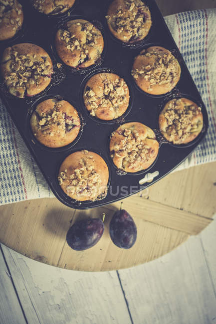 Freshly baked Plum muffins on baking dish — Stock Photo