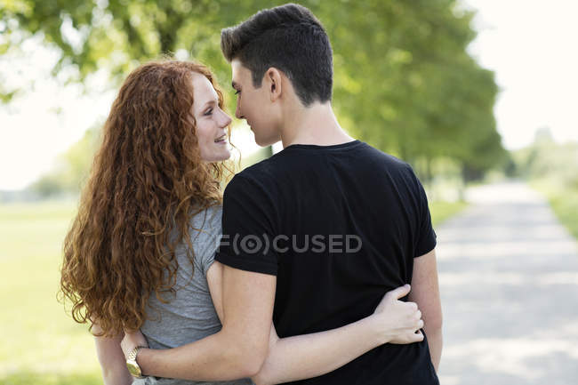 Teenage Couple In Love Arm In Arm Outdoors Lovers Positive Stock Photo