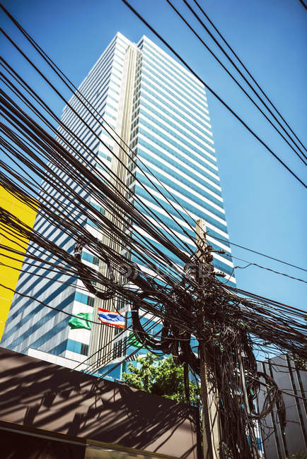 Thailand, Bangkok, tangled and messy electrical cables against sky — Stock Photo