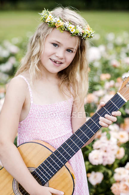 Smiling girl wearing floral wreath — Stock Photo