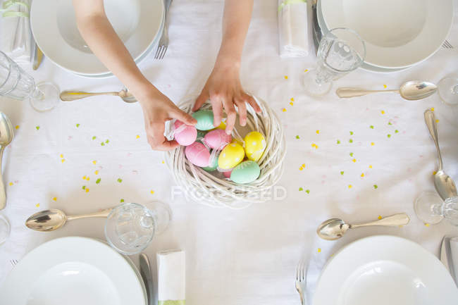 Little Girl Decorating Dining Table, Round Table Easter Hours